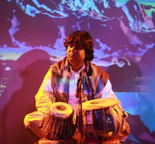 A portrait taken during a performance with a beautiful, artistic projection in the background. The quote reflects my belief that music's purpose is to bring happiness.