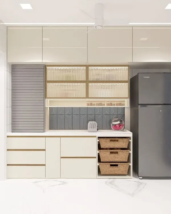 This kitchen is designed for ultimate efficiency, incorporating the laundry area, refrigerator, and pantry storage into one cohesive wall. We used wicker baskets for vegetable storage and a rolling shutter to conceal small appliances, keeping the countertops clutter-free.