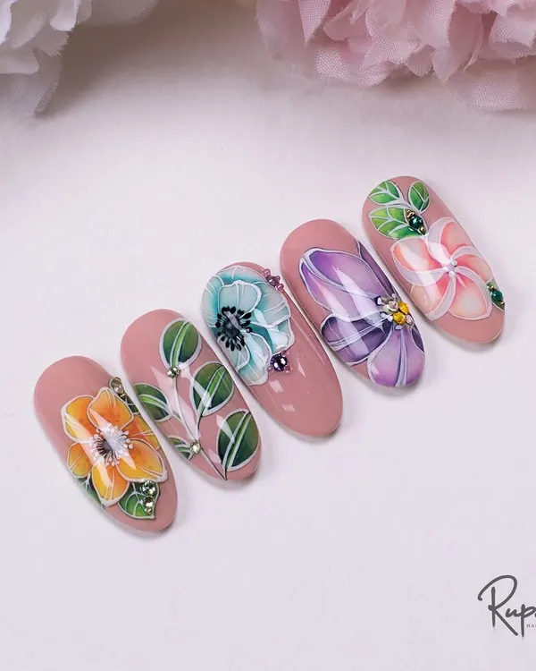 A set of five nails featuring delicate, hand-painted watercolor-style flowers on a soft pink base. I've added tiny crystals for a touch of morning dew.