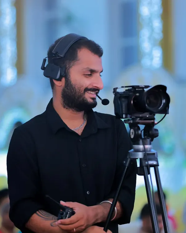 A candid shot of me at work, operating a camera with a headset on a professional set. This shows my experience and focus as a Director of Photography during a shoot.