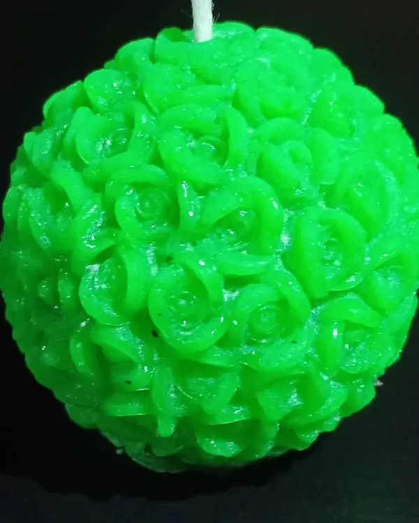 A close-up of my green rose ball candle, showing the detailed petals carved from wax. This spherical candle is a unique decorative object that looks beautiful from every angle.