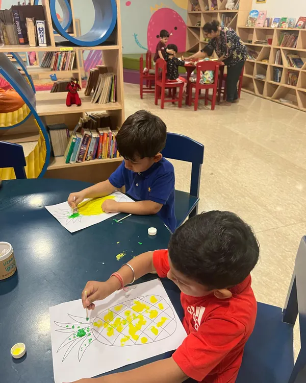 Our toddlers program is in full swing with some fruity fun. Here, the children are enjoying a painting session, creating their own colorful pineapples. This activity is great for color recognition and hand eye coordination.