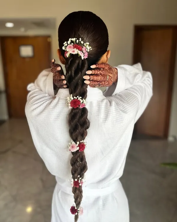 A behind-the-scenes look at Neha's stunning floral braid. Even in a simple bathrobe, the hairstyle is a work of art. Her natural hair had incredible length and volume, no extensions needed.