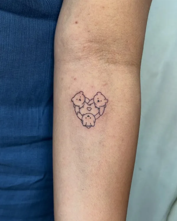 A fine-line tattoo of three little bears in a heart, symbolizing the unbreakable bond between three sisters. This minimalist design is a permanent reminder of their shared childhood and lifelong unity.