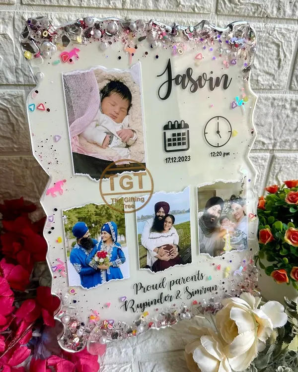 This 9x12 inch resin frame is designed to celebrate a new baby. It features the baby's name, birth date, and time, along with a newborn photo and pictures of the proud parents.
