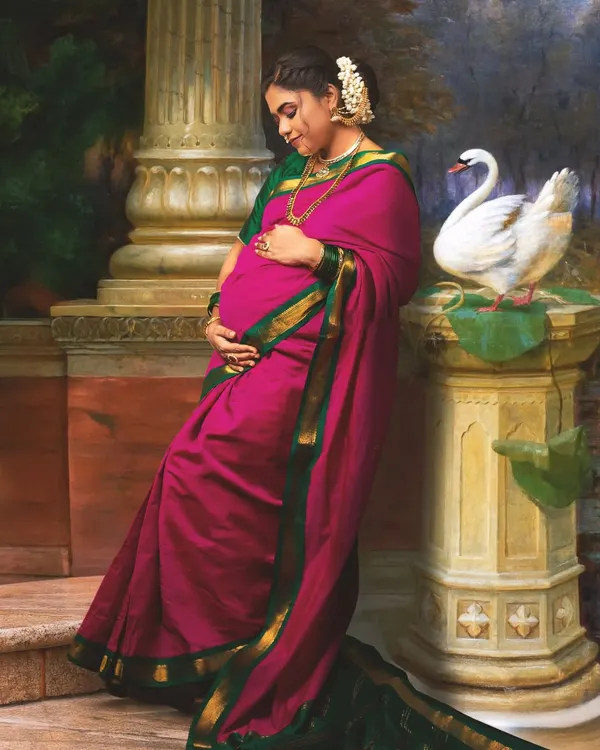 A maternity portrait reimagined from a classic Raja Varma painting. The pose is carefully adapted to gracefully feature the baby bump, blending classical art with the personal story of motherhood.