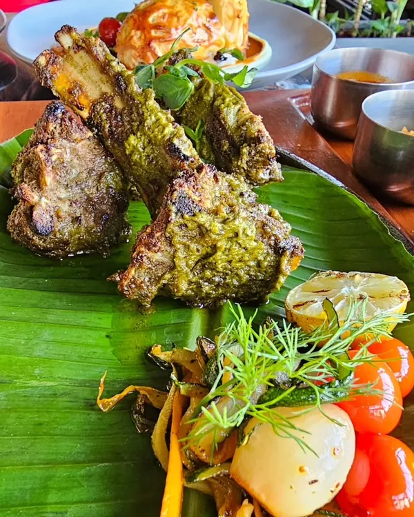 Grilled lamb chops on a banana leaf. This is proof that you can eat delicious, high-protein meals that feel like a treat while still working towards your goals.