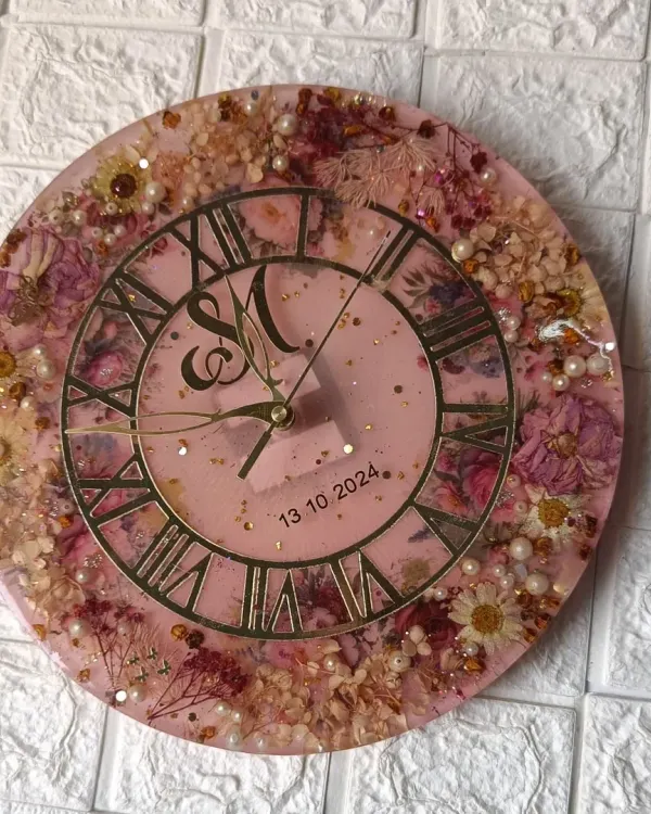 This 12-inch wall clock was made with a client's varmala flowers. I added extra flowers to create this full, beautiful design on a soft pink base with a classic Roman numeral dial.
