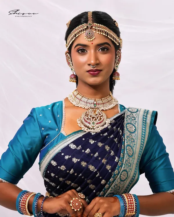 This is the art I create. A complete traditional bridal look featuring intricate makeup, classic hairstyling, and perfect saree draping that honors our heritage while making you feel like royalty on your special day.