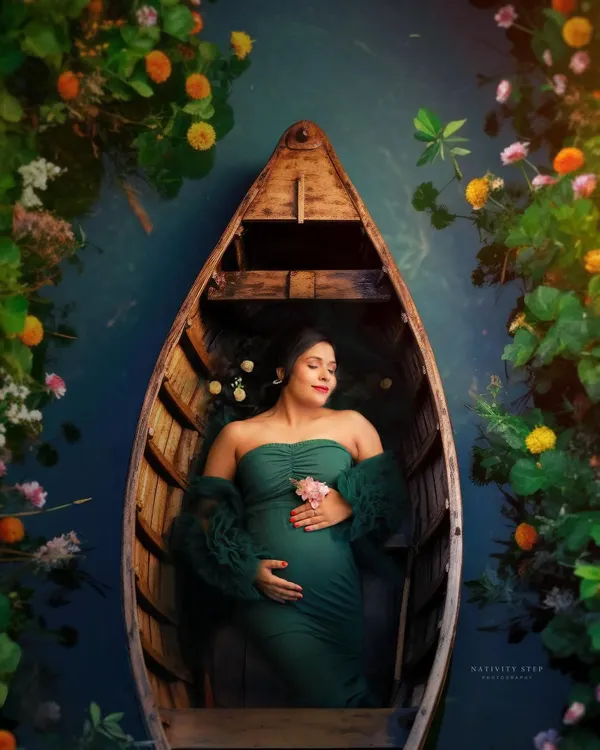 This creative portrait captures the serene and magical feeling of pregnancy. We use artistic concepts like this boat setup to create truly unique and breathtaking images that feel like a dream.