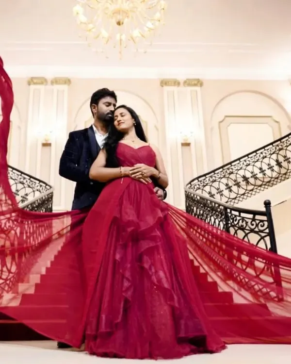 This is the moment I live for. A stunning couple, a grand staircase, and our signature red flying gown creating a scene straight out of a movie. This is the kind of epic, romantic memory I want to help you create.