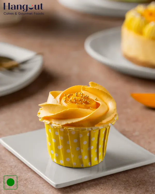 A golden swirl with a juicy thrill. Our Mango Cupcake is the perfect way to say hello to summer, with a surprise mango filling inside a light and fluffy cake.