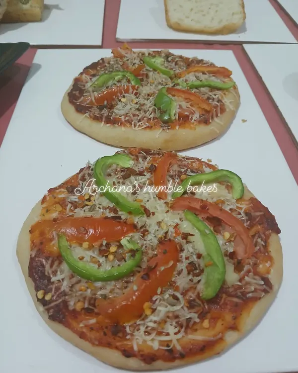 You can make your own healthy, yeast-free pizza at home. Here are some delicious pizzas made by students in my workshop using our special Jain-friendly recipe.