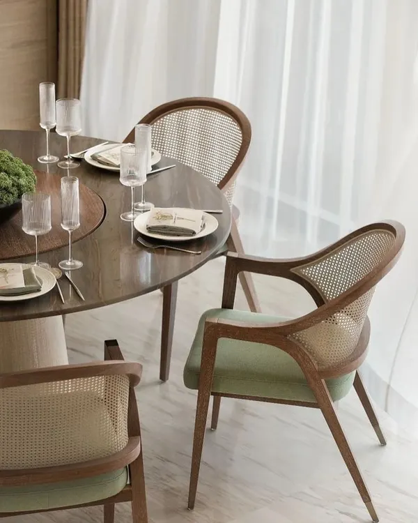 A perfect example of classic elegance, these dining chairs feature a beautiful teak wood frame with a woven rattan back. The soft green velvet seat adds a touch of color and comfort, ideal for long dinners.