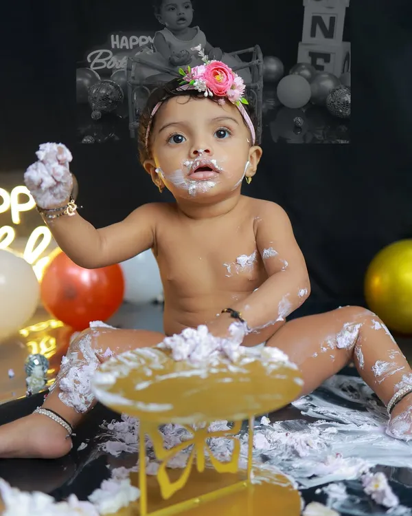 The perfect cake smash moment. This little one is having the time of her life, and her expression of pure, frosting-covered joy is what these sessions are all about.