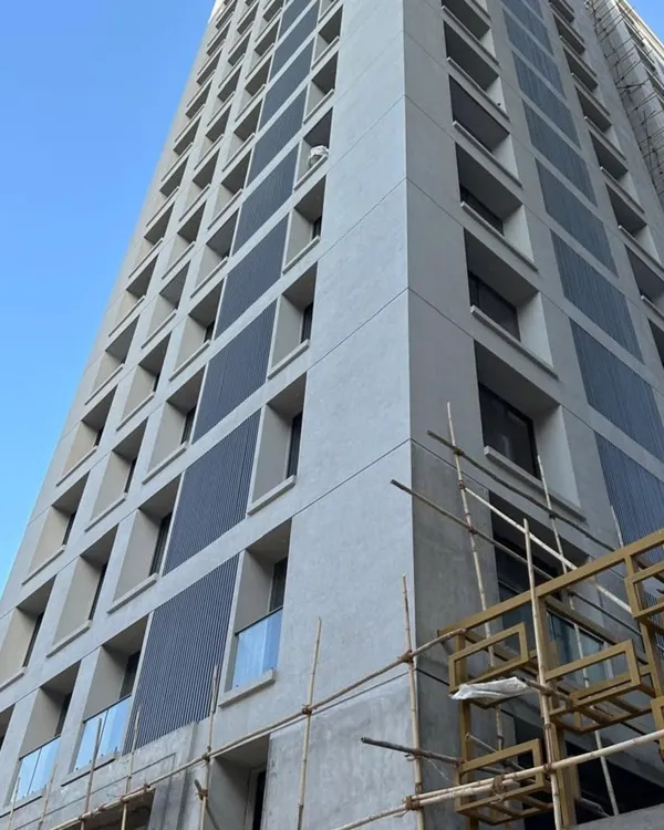 A high-rise project in progress, featuring panels of our dark metal cladding. This shows our capability to execute large-scale facade installations that give a modern, industrial look to any building.