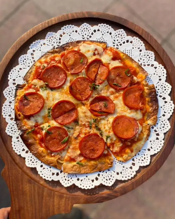 Our classic pepperoni pizza, a true crowd-pleaser. We make our dough fresh and hand-stretch it for that perfect thin crust, then top it with rich tomato sauce, mozzarella, and generous slices of pepperoni. It's simple, authentic Italian flavor at its best.