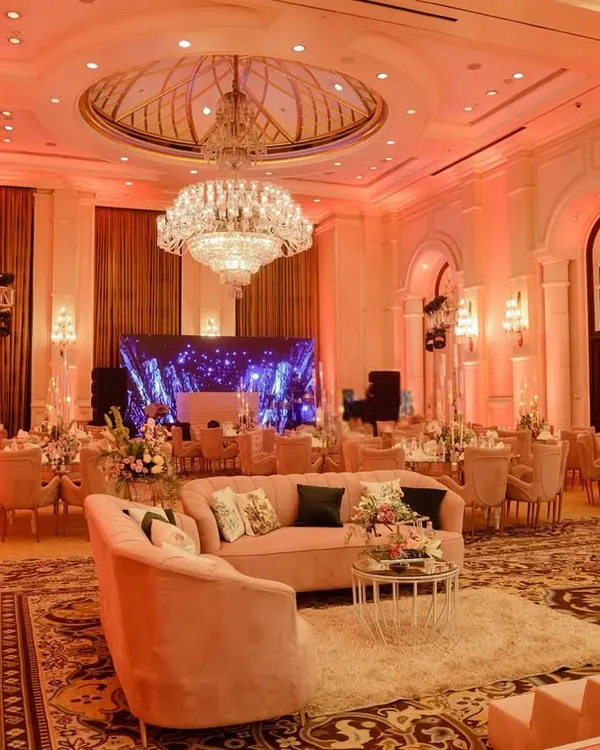 A wide view of this grand ballroom, which I transformed for a ring ceremony using a palette of blush pink, soft lighting, and elegant floral arrangements.