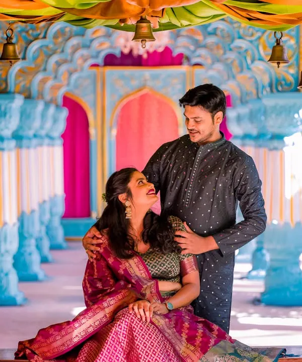 A candid, loving gaze on a decorated swing. The vibrant colors and traditional attire make this a joyful and beautiful pre-wedding portrait.