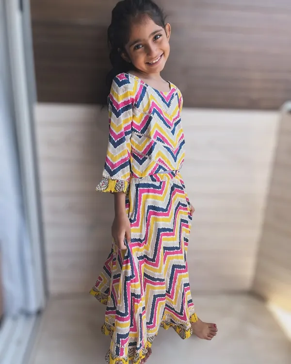 A burst of color and playful chevron prints. This vibrant dress is made from the softest cotton, perfect for a little one with a personality just as vibrant. The tassel detailing adds a fun, twirl-worthy touch.