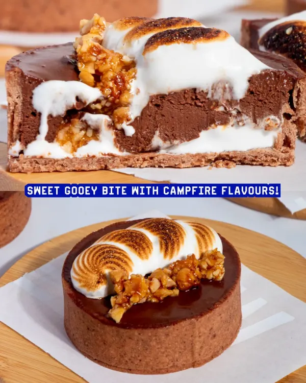 Our S'mores Tart is pure indulgence. It features a crisp chocolate shell, molten dark chocolate ganache, hazelnut praline, and a toasted marshmallow crown.