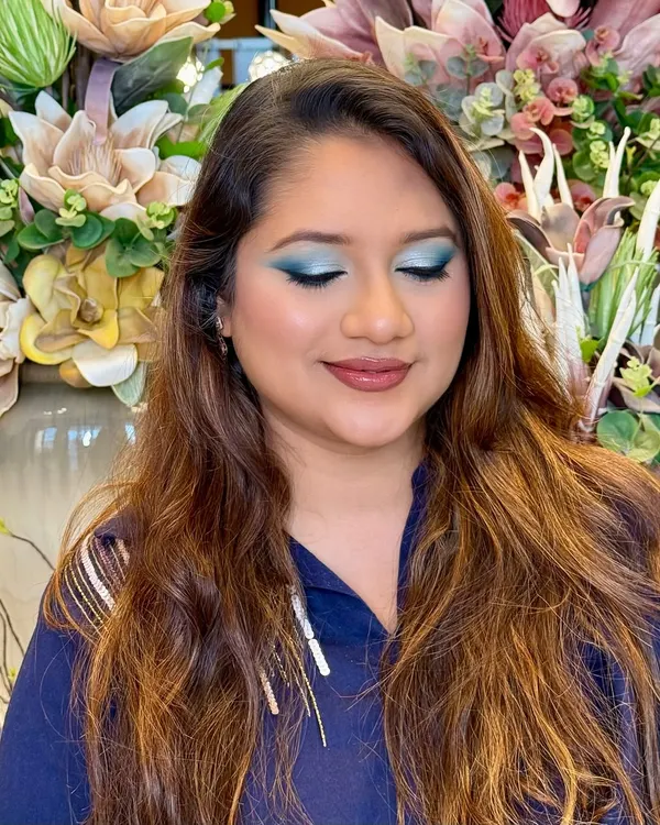 A bold pop of teal with soft glam skin. This look is all about confidence, with a clean blend, a luminous base, and an eye-catching statement shadow.