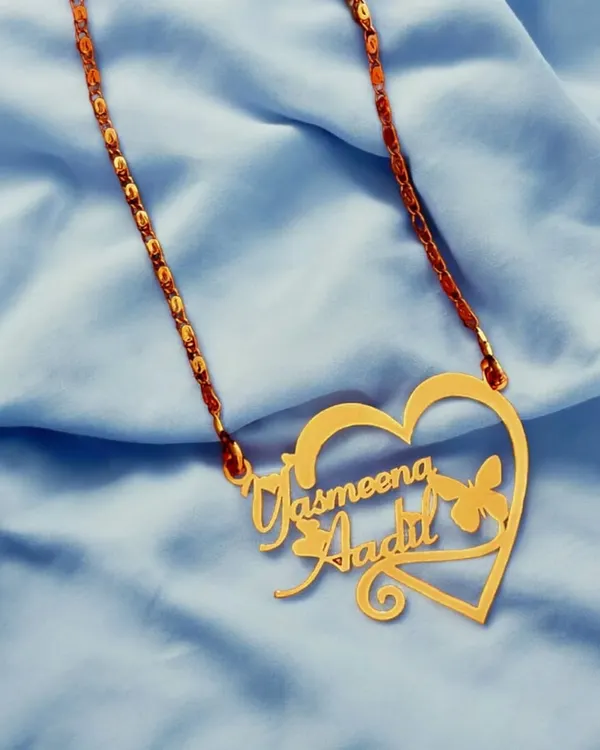 This double-name pendant features two names elegantly woven into a heart-shaped frame with a butterfly accent. It’s a popular design for couples, crafted to celebrate your connection.