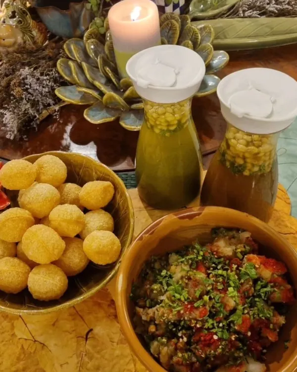A cozy and inviting pani puri setup, perfect for a small gathering. We provide the crispy puris, the flavorful potato filling, and two kinds of freshly made pani: spicy and sweet.