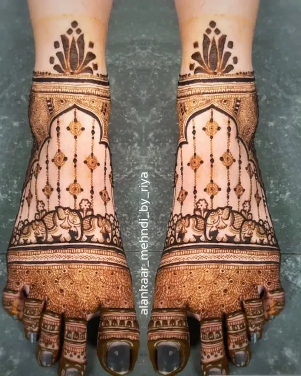 An elegant and symmetrical design for bridal feet, featuring hanging ornaments and elephant motifs within a traditional border.