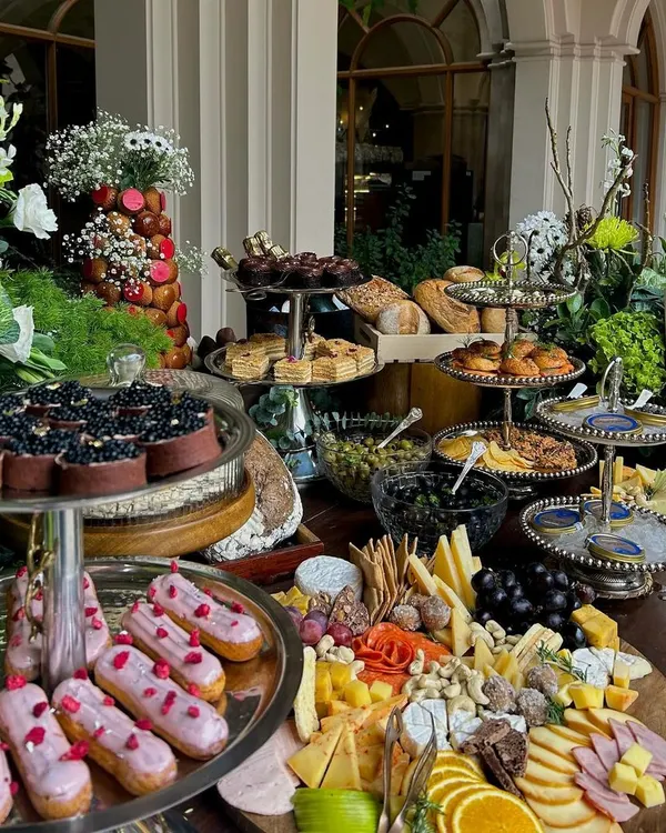We believe every celebration deserves a touch of extravagance. This magnificent grazing table, overflowing with artisanal cheeses, cured meats, fresh fruits, and gourmet accompaniments, is the heart of any party, inviting guests to gather and indulge.