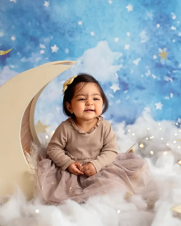 Even the cutest babies have their teary moments, and I think they are just as important to capture. This little one on the moon prop is adorable, even with a sad face.