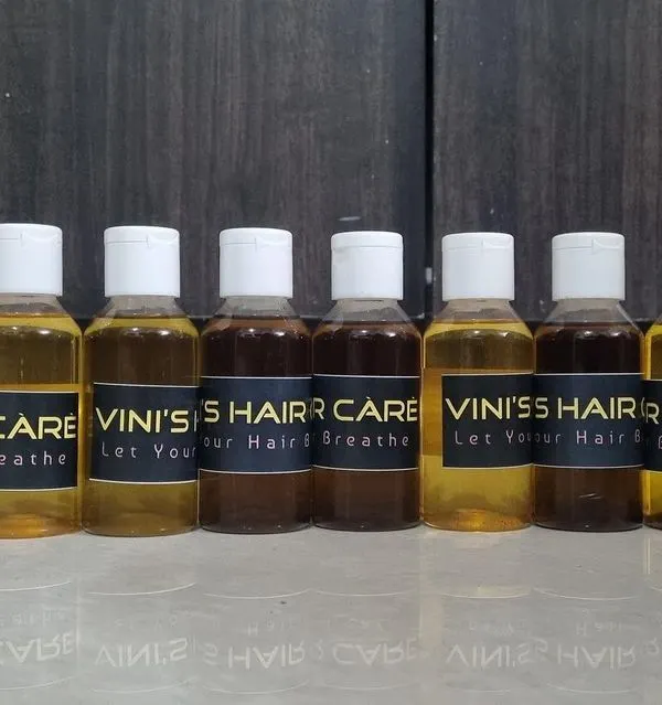 A lineup of freshly prepared customized hair oils, each with a unique blend of herbs for different hair concerns. You can see the variation in color based on the ingredients.