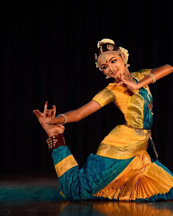 We believe dance is a powerful form of expression. Here, one of our senior students showcases the incredible flexibility and grace honed through dedicated Bharatanatyam training, capturing a moment of pure artistry on stage.