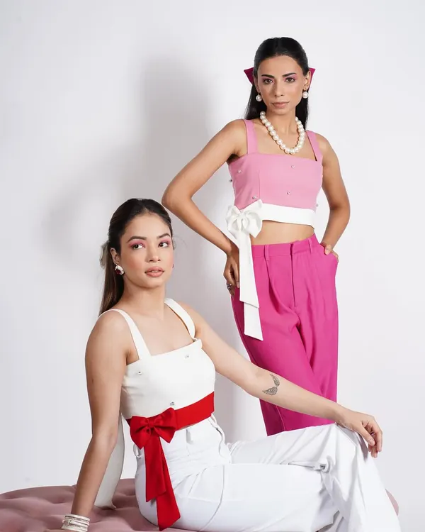 A dual-model shot for a contemporary brand, showcasing two coordinated but distinct looks. I focused on creating a visual dialogue between the models through complementary colors and contrasting accessories like bows and pearls.