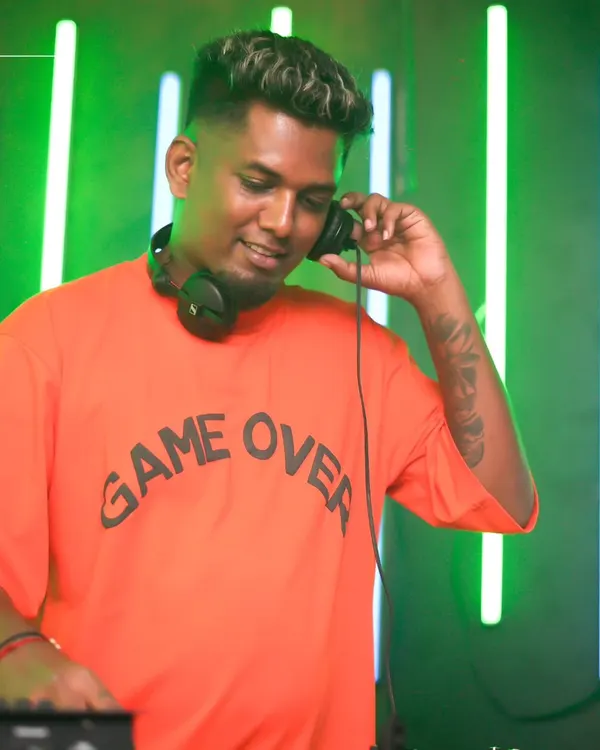 A candid shot of me listening to the mix on my headphones. This is me in my element, focused on the sound against a cool neon green backdrop.