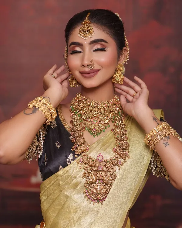 This golden tissue silk saree is a showstopper for any reception. I paired it with a contrasting black blouse that has heavy gold embroidery for a look that is both modern and regal.