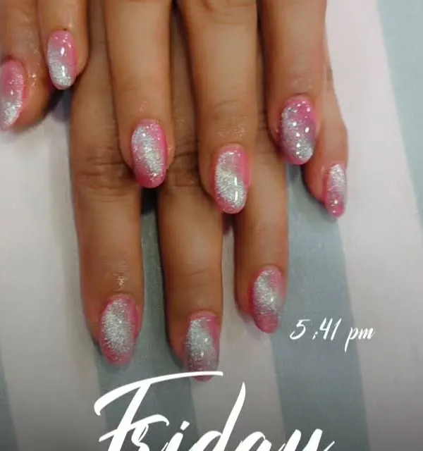 A full-on glamour look with pink and silver glitter ombre on almond-shaped nails. The glitter is concentrated at the base and fades towards the tips, creating a beautiful gradient effect.