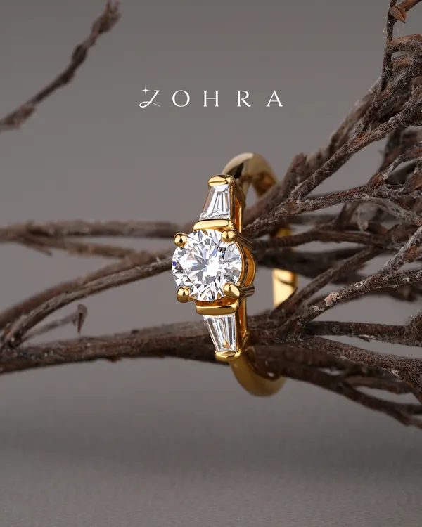 A promise of forever should be as unique as your love story. This bespoke engagement ring features a brilliant-cut centre diamond, flanked by elegant baguette diamonds on a polished 18k gold band. I work with each client to ensure every element, from the diamond's cut to the band's design, perfectly captures their vision.
