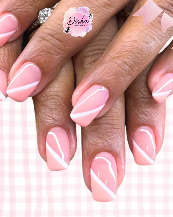 Soft, classy, and timeless. These pastel pink nails with crisp white diagonal lines are the perfect blend of elegance and simplicity.
