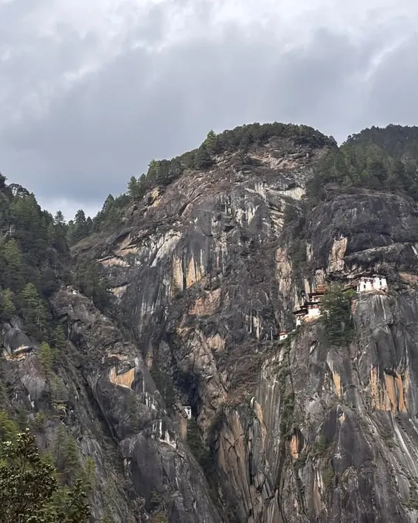 This is the world famous Tiger’s Nest Monastery in Bhutan, seen from the trail. The monastery clings to a sheer cliff face, and the trek to reach it is the main highlight of my 7-day all-inclusive Bhutan trip. The view itself is worth the journey.