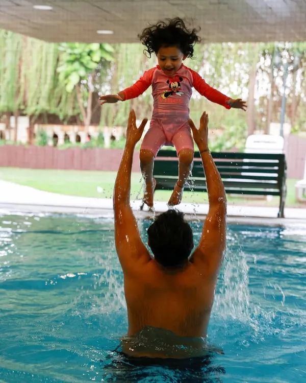 Pure joy in its most energetic form! An at-home lifestyle shoot can even end with a splash in the pool. I love capturing the fun and unscripted moments of a family just being themselves.
