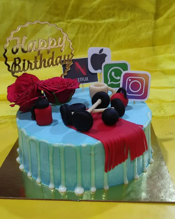 This cake is for the person who loves the gym but also enjoys scrolling through social media. It features fondant dumbbells alongside popular app logos like Instagram and Netflix, plus a fresh rose for a touch of elegance.