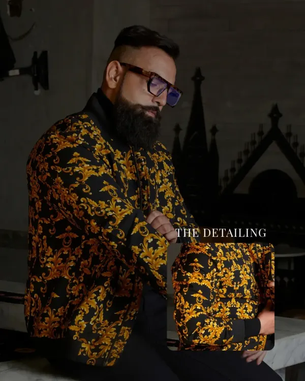 This jacket is luxuriously bold. The rich baroque pattern in gold on a black base is crafted for those who wear confidence as a second skin. The inset shows the fine detailing of the print.