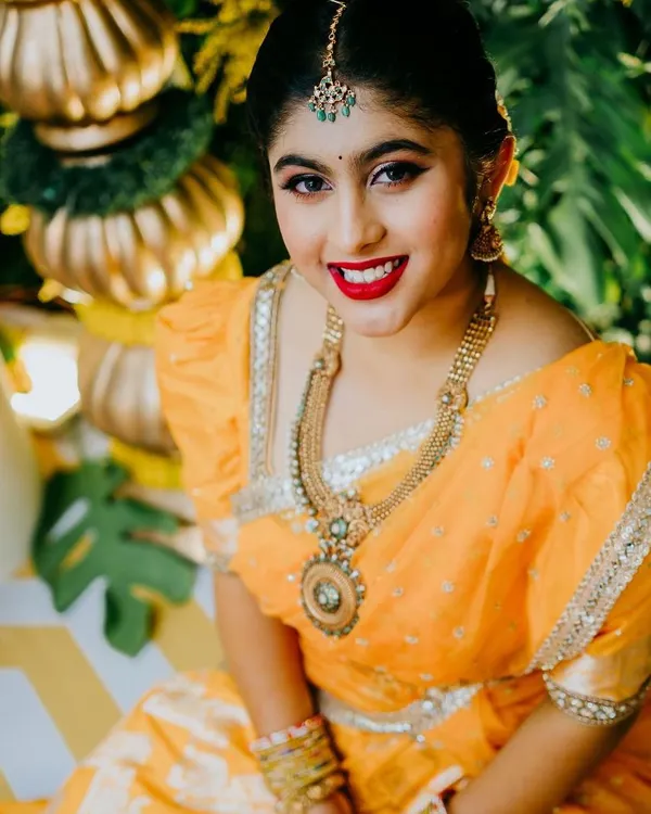 A stunning picture from a Haldi ceremony. The client is glowing in her yellow saree, and I paired it with a classic red lip and defined eyes for a look that is both traditional and vibrant.