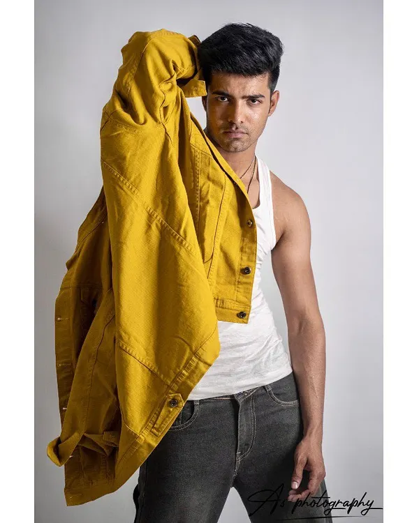 A strong studio portrait with a pop of color from the yellow jacket. This type of image is great for a model's portfolio, showing how they can carry a bold fashion piece.