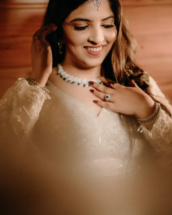 A radiant bridal portrait of Nikita. Her joyful smile and the soft lighting create a warm and timeless image that captures her happiness.