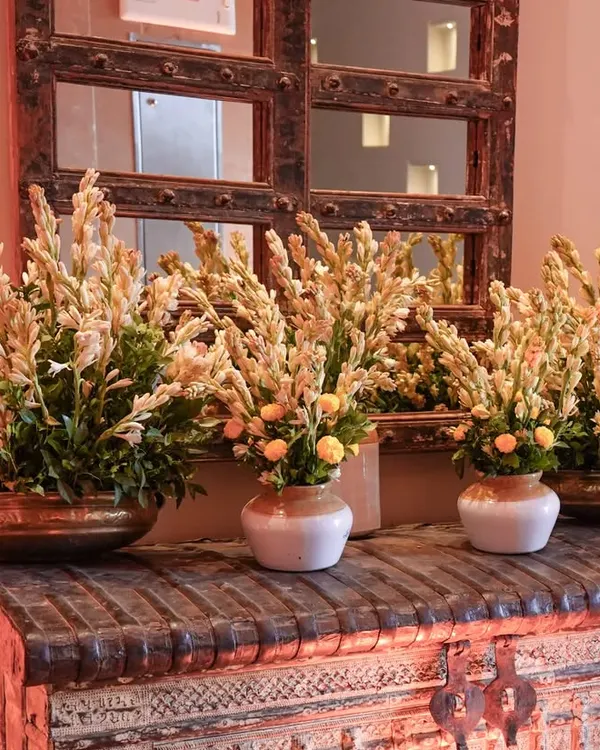 The timeless elegance of Rajnigandha (tuberose). We used these fragrant flowers in traditional brass and ceramic vases to create a beautiful and aromatic welcome for a puja ceremony.