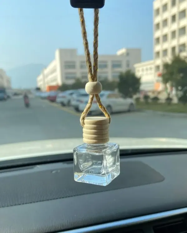 Here is my hanging air freshener in its natural habitat, keeping the car interior fresh. The compact glass bottle and wooden cap are designed to be unobtrusive and stylish.