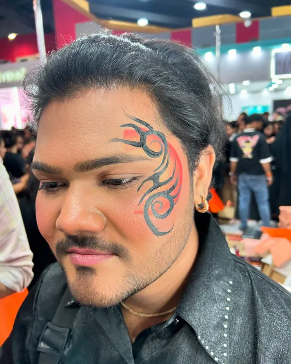 Face painting is not just for girls, DUH! This cool tribal design with a pop of red is a great example of the kind of art I do for men.