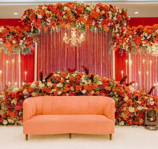 For Gladys and Jerin's reception, we went for bold romance. The stage was enveloped in a sea of rich red florals, accented with warm candlelights and a statement chandelier, creating a passionate and luxurious ambiance for their celebration.